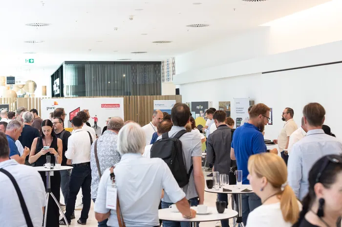 Networking area with sponsor booths and attendees